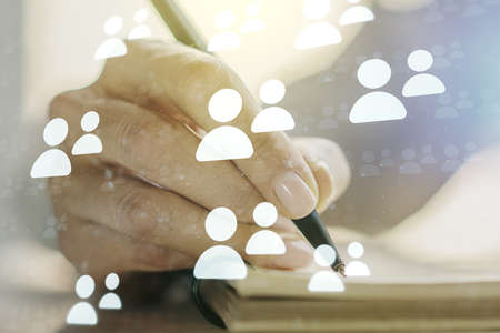 Social network media concept with woman hand writing in diary on background. Double exposureの写真素材