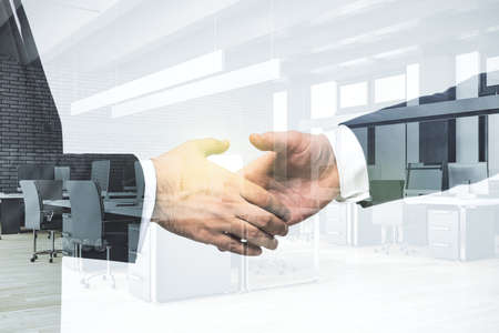Handshake of two businessmen on modern furnished office interior background, deal and partnership concept. Multiexposureの写真素材