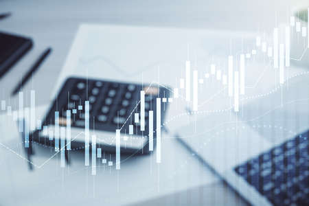 Multi exposure of virtual abstract financial diagram on calculator and pc background, banking and accounting conceptの写真素材