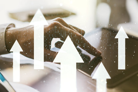 Creative abstract upward arrows hologram and finger presses on a digital tablet on background,...