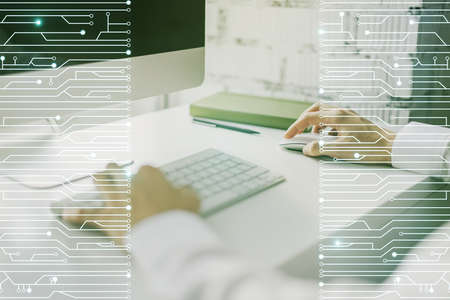 Double exposure of circuit hologram and hands typing on laptop on background. Research and development hardware conceptの写真素材