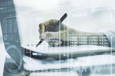 Double exposure of abstract creative statistics data hologram with hand writing in notepad on background with laptop, analytics and forecasting conceptの写真素材