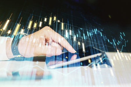 Multi exposure of abstract creative financial graph with finger presses on a digital tablet on...