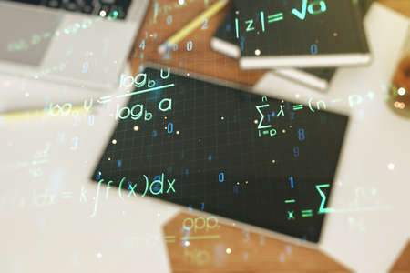 Creative scientific formula hologram and modern digital tablet on background, research concept. Multiexposureの写真素材