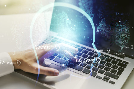 Creative artificial Intelligence concept with human head sketch and hands typing on computer...