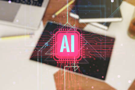Creative artificial Intelligence symbol concept and modern digital tablet on desktop on background, top view. Double exposureの写真素材