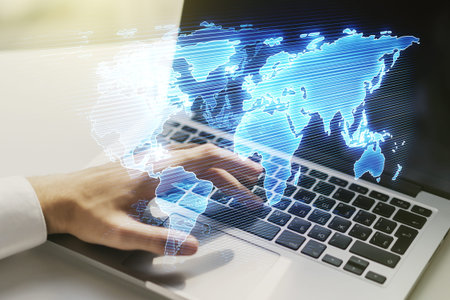 Multi exposure of abstract creative digital world map and hands typing on computer keyboard on...