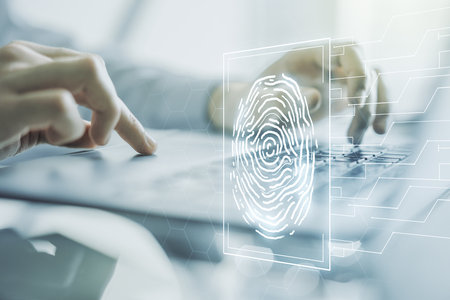 Multi exposure of creative fingerprint hologram with hands typing on computer keyboard on background, personal biometric data conceptの写真素材