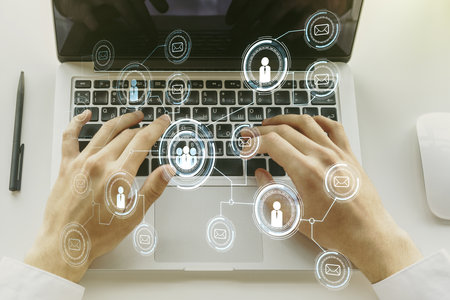 Double exposure of social network icons concept with hands typing on laptop on background. Marketing and promotion conceptの写真素材