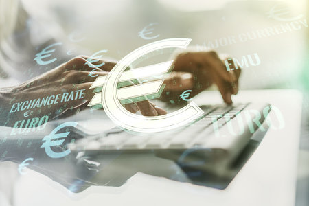 Creative EURO symbols sketch and hands typing on computer keyboard on background, strategy and forecast concept. Multiexposureの写真素材