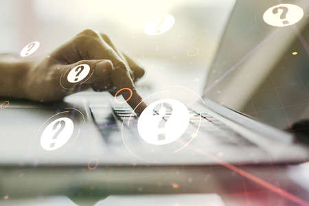 Double exposure of question mark hologram and hands typing on laptop on background. Sociology and psychology conceptの写真素材