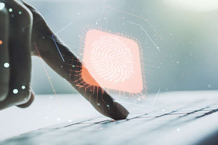 Multi exposure of abstract fingerprint scan interface with hands typing on computer keyboard on background, digital access conceptの写真素材