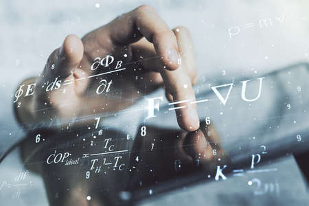 Double exposure of creative scientific formula concept with finger clicks on a digital tablet on background, research and development conceptの写真素材