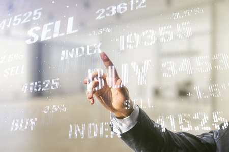 Man hand presses on abstract virtual financial graph on blurred office background, financial and trading concept. Multiexposureの写真素材