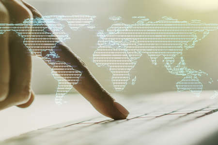 Abstract creative world map and hands typing on laptop on background, international trading concept. Multiexposureの写真素材