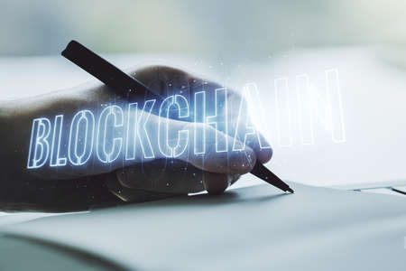 Creative concept of blockchain technology and man hand writing in notebook on background. digital money transfers and decentralization concept. Multiexposureの写真素材