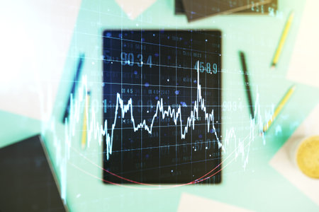 Double exposure of abstract creative financial diagram and modern digital tablet on background,...
