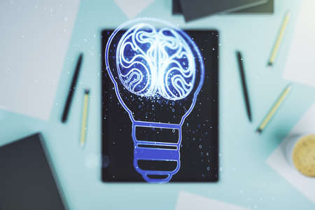 Creative light bulb with human brain hologram and modern digital tablet on background, artificial Intelligence and neural networks concept. Multiexposureの写真素材
