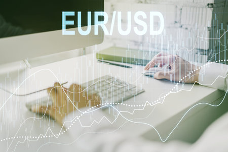Double exposure of creative EURO USD forex chart hologram and hands typing on laptop on background....