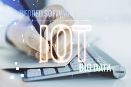 Double exposure of creative IOT hologram with hand writing in notebook on background with laptop,...