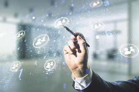 Double exposure of man hand with pen working with social network icons hologram and world map on blurred office background. Marketing and promotion conceptの写真素材