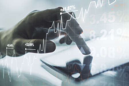 Multi exposure of abstract creative financial chart with finger presses on a digital tablet on background, research and analytics conceptの写真素材