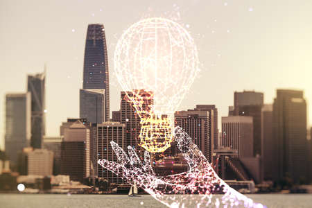 Abstract virtual light bulb hologram on San Francisco office buildings background, idea concept. Multiexposureの写真素材