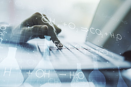 Creative chemistry concept with hands typing on laptop on background. Multiexposure