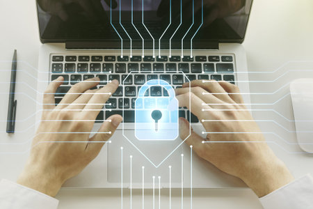 Double exposure of creative lock hologram with chip and hands typing on laptop on background....