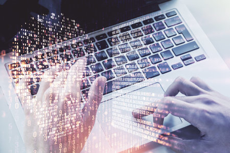 Creative concept of code skull illustration and hands typing on laptop on background. Hacking and...