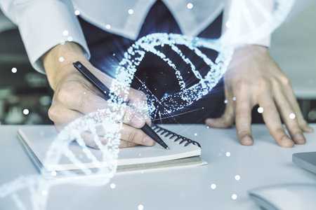 Creative light DNA illustration and hand writing in diary on background with laptop, science and biology concept. Multiexposureの写真素材