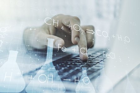 Creative chemistry concept with hands typing on laptop on background. Multi exposure