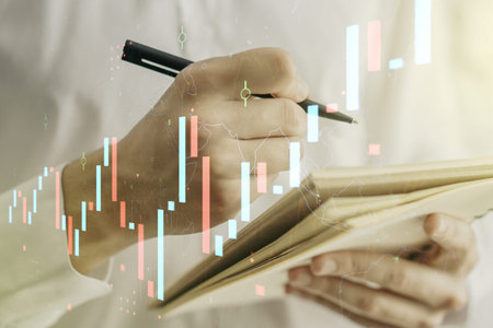 Abstract creative financial graph with hand writing in notebook on background, forex and investment...