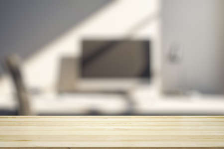 Blank wooden office desk with light workplace with laptop on background, mock upの写真素材