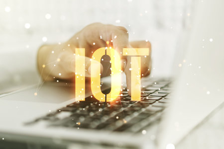Double exposure of creative IOT hologram with hands typing on laptop on background, research and...