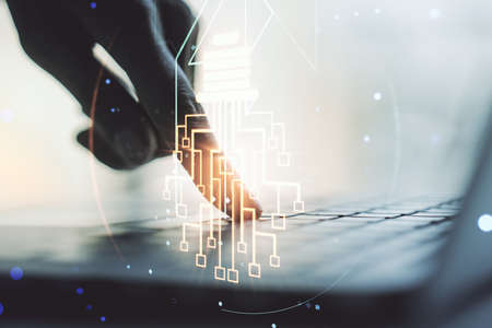 Creative idea concept with light bulb and microcircuit illustration and hands typing on laptop on background. Neural networks and machine learning concept. Multiexposureの写真素材