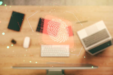 Multi exposure of creative fingerprint hologram on laptop background, personal biometric data conceptの写真素材