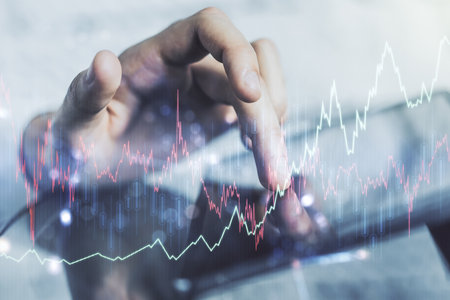 Double exposure of abstract creative financial chart with finger clicks on a digital tablet on background, research and strategy conceptの写真素材