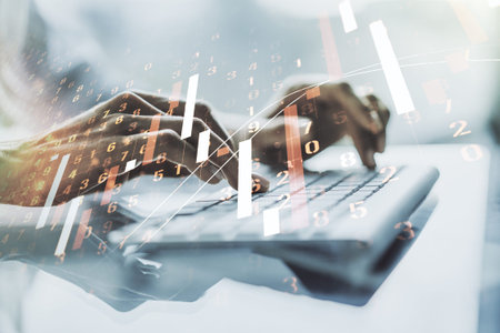 Double exposure of abstract creative financial chart with hand typing on computer keyboard on...