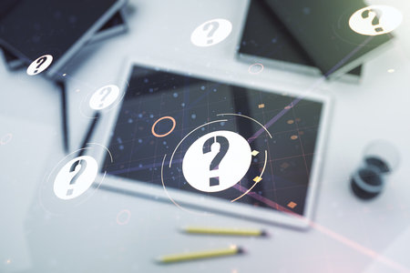Creative abstract question mark hologram and modern digital tablet on desktop on background, top view, future technology concept. Multi exposureの写真素材