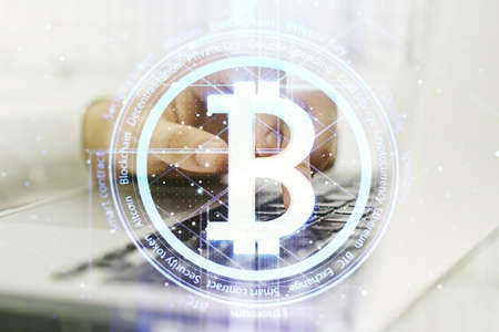 Creative Bitcoin concept with hands typing on laptop on background. Multi-exposureの写真素材