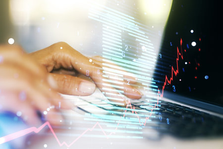 Double exposure of creative Bitcoin symbol with hands typing on laptop on background. Cryptocurrency...