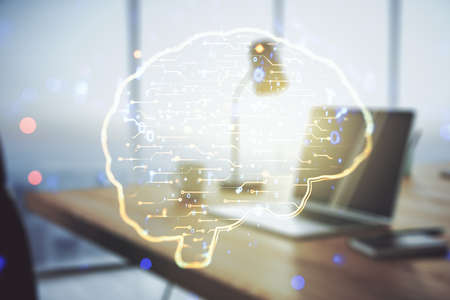 Creative artificial Intelligence concept with human brain hologram on modern laptop background. Multi-exposureの写真素材