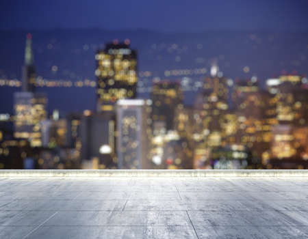 Empty concrete dirty rooftop on the background of a beautiful blurry San Francisco city skyline at night, mock upの写真素材