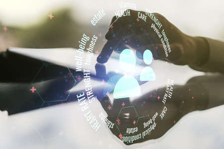 Double exposure of people icons hologram and finger clicks on a digital tablet on background. Online insurance service conceptの写真素材