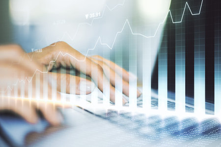 Multi exposure of abstract creative financial chart with hand typing on computer keyboard on...