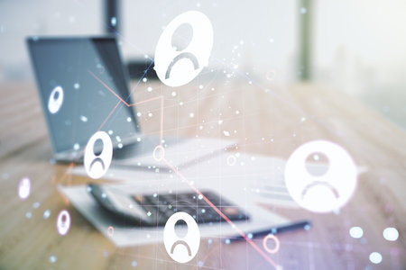 Double exposure of abstract virtual social network icons on blurry calculator with laptop background. Marketing and promotion conceptの写真素材