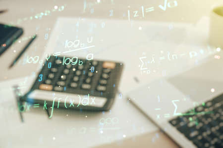 Double exposure of scientific formula hologram on blurry calculator with laptop background, research and development conceptの写真素材