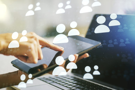 Double exposure of social network icons concept with finger clicks on a digital tablet on...