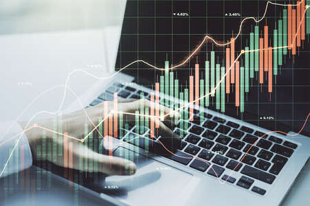 Double exposure of abstract creative financial diagram with hand typing on computer keyboard on background, banking and accounting conceptの写真素材